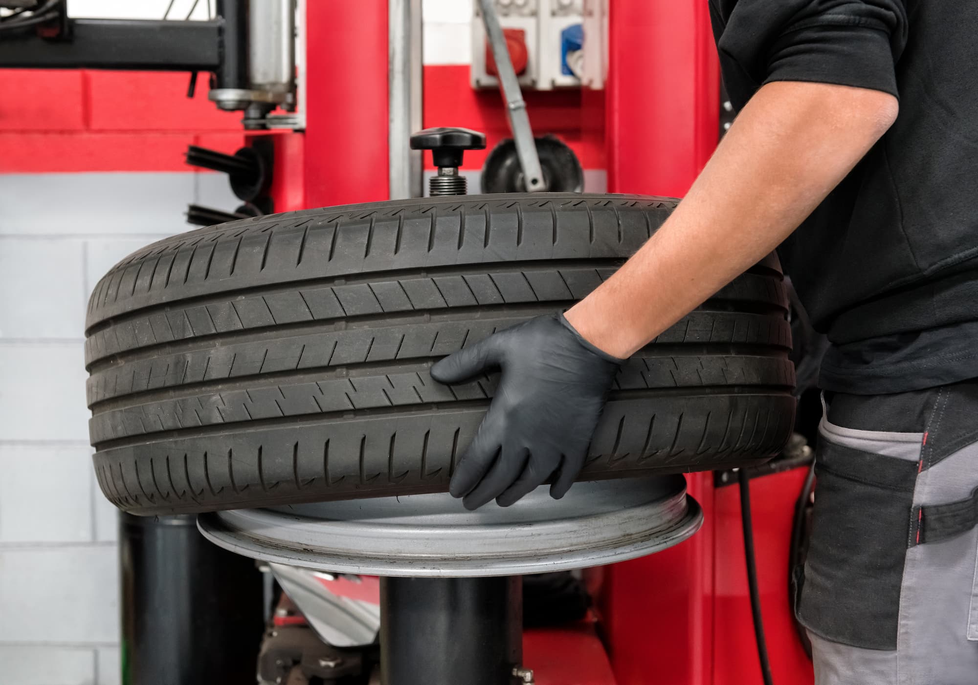 a technician rotating car tires